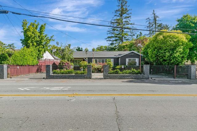 a view of a brick house with a large window