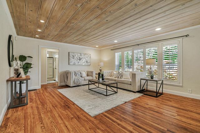 a living room with furniture rug and wooden floor