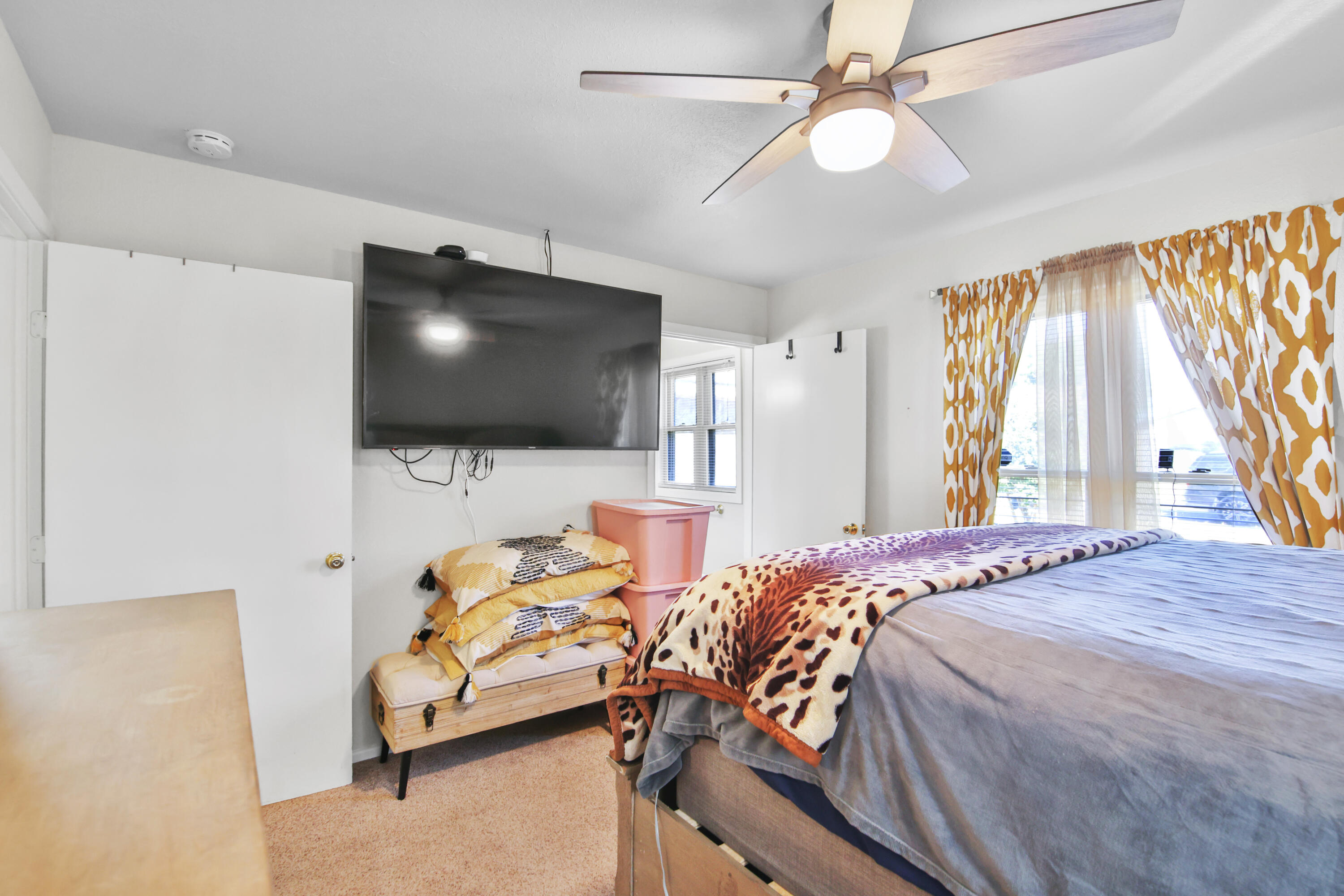 5625 Amherst Street Lubbock, TX 79416 - Photo 19 of 32 a bedroom with a bed and a flat screen tv