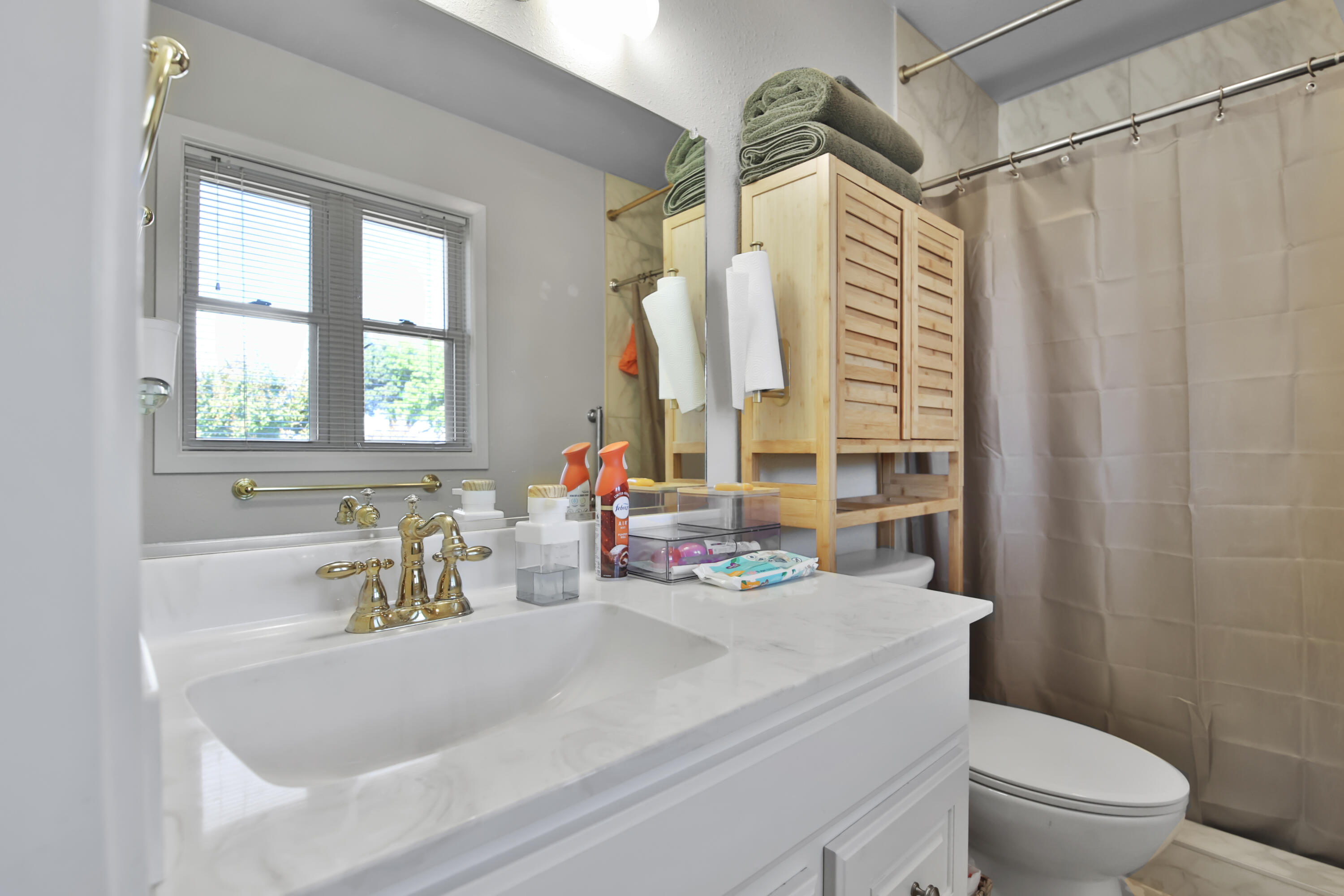 5625 Amherst Street Lubbock, TX 79416 - Photo 22 of 32 a bathroom with a sink a toilet and a window