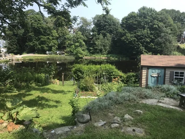 a backyard of a house with a yard and outdoor seating