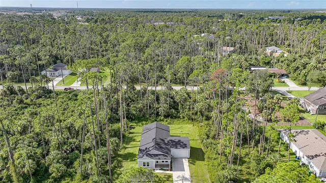 a aerial view of a house with a yard basket ball court and outdoor seating