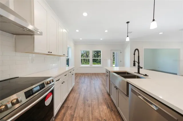 a kitchen with a sink stove and cabinets