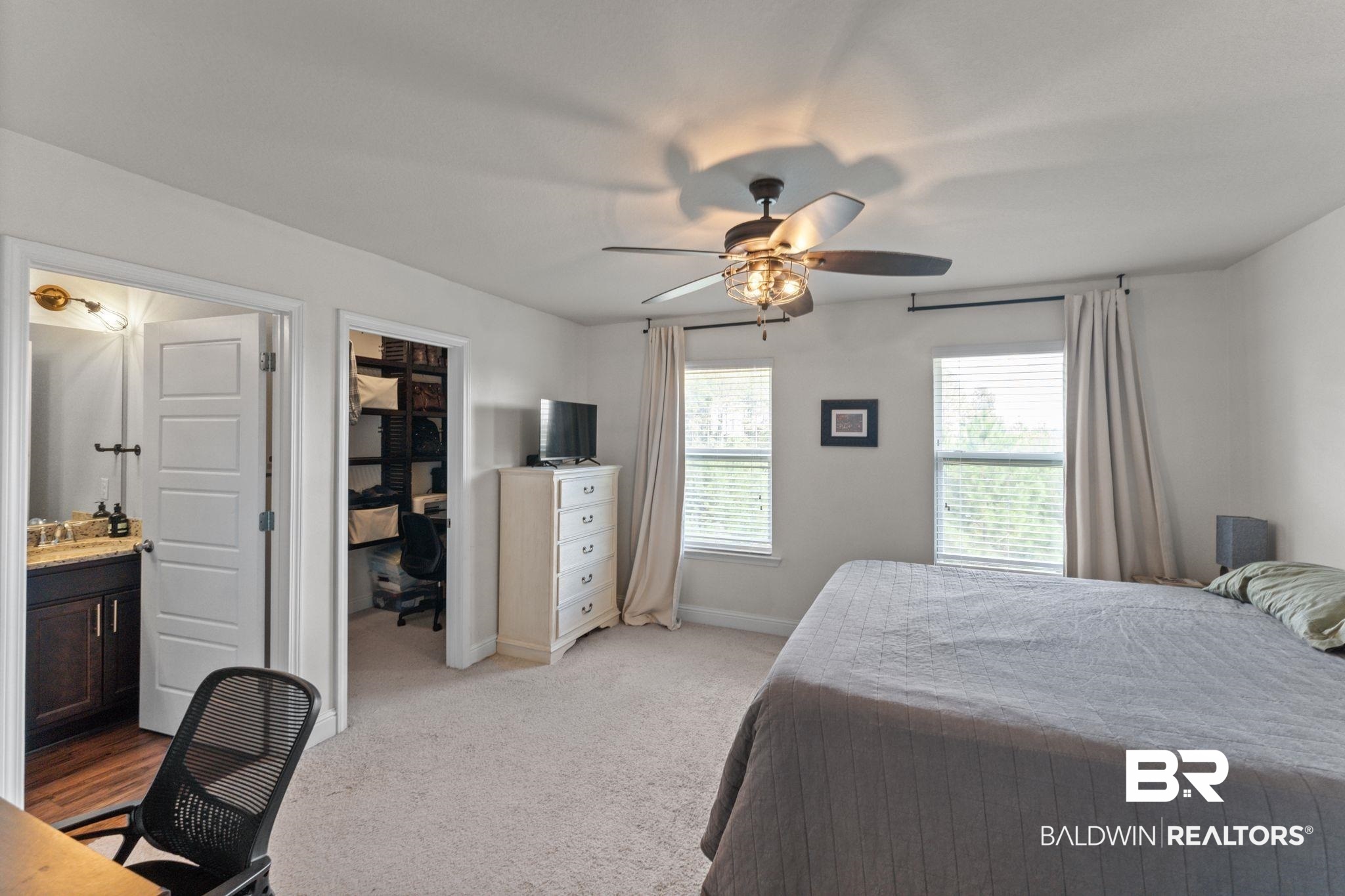 12711 Chickadee Lane Daphne, AL 36527 - Photo 18 of 39 Bedroom with an office area, light carpet, a ceiling fan, a walk in closet, and ensuite bath