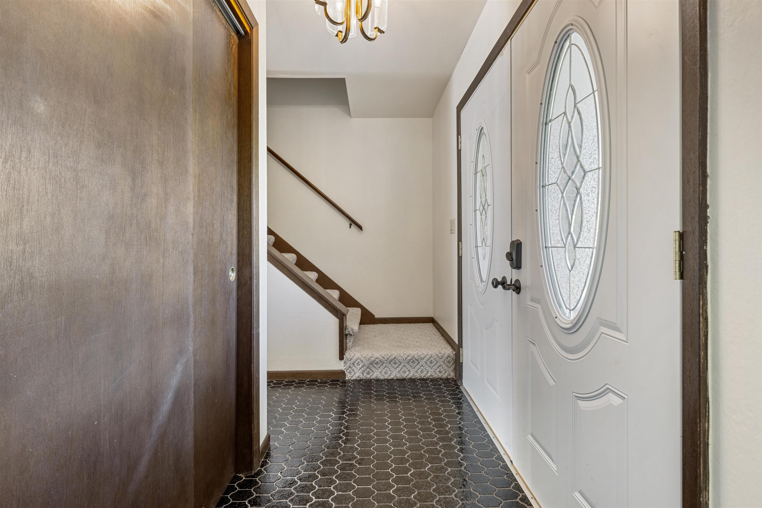 7660 Stephens Road Rockton, IL 61072 - Photo 4 of 34 a view of a hallway with wooden floor and staircase