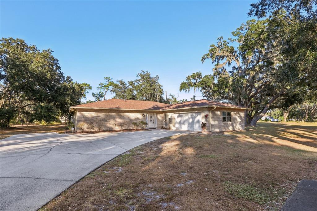 5706 Durant Road Dover, FL 33527 - Photo 1 of 1 a view of a yard with an trees in the background