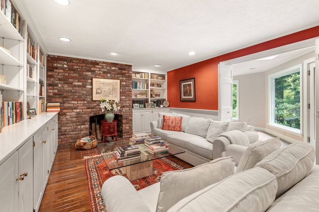 17 Fields Pond Road Weston, MA 02493 - Photo 11 of 41 a living room with furniture a fireplace and a large window