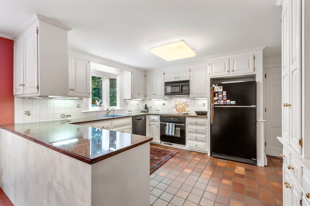 17 Fields Pond Road Weston, MA 02493 - Photo 13 of 41 a kitchen with stainless steel appliances granite countertop a refrigerator a stove a sink a microwave and a dining table