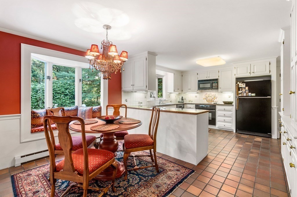 17 Fields Pond Road Weston, MA 02493 - Photo 14 of 41 a dining room with furniture a chandelier and kitchen view