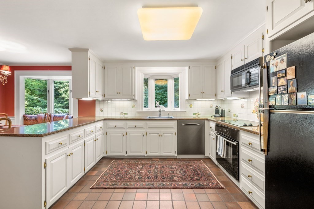 17 Fields Pond Road Weston, MA 02493 - Photo 16 of 41 a kitchen with a sink stove and cabinets