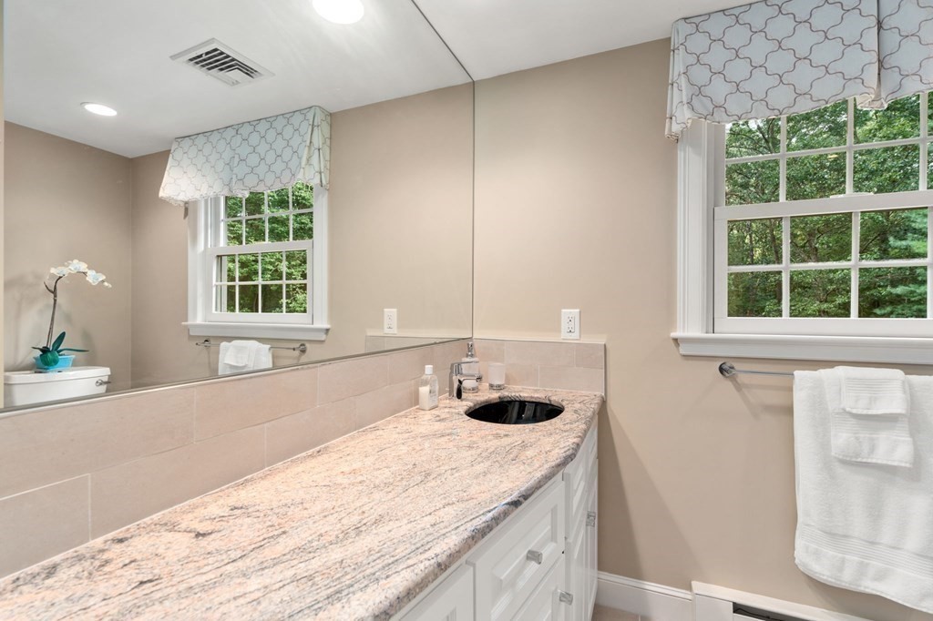 17 Fields Pond Road Weston, MA 02493 - Photo 25 of 41 a bathroom with a granite countertop sink and a window
