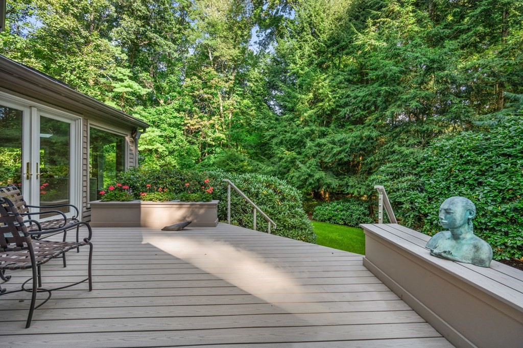 17 Fields Pond Road Weston, MA 02493 - Photo 31 of 41 a view of a roof deck with table and chairs potted plants with wooden floor and fence