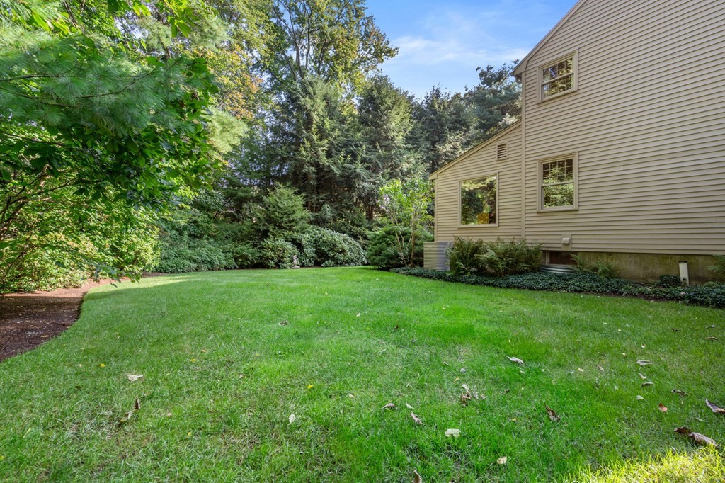 17 Fields Pond Road Weston, MA 02493 - Photo 37 of 41 a view of a backyard with potted plants and large trees