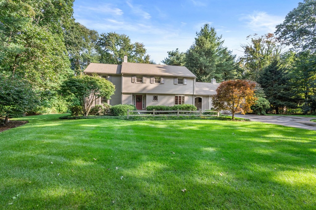 17 Fields Pond Road Weston, MA 02493 - Photo 4 of 41 a front view of a house with a yard table and chairs