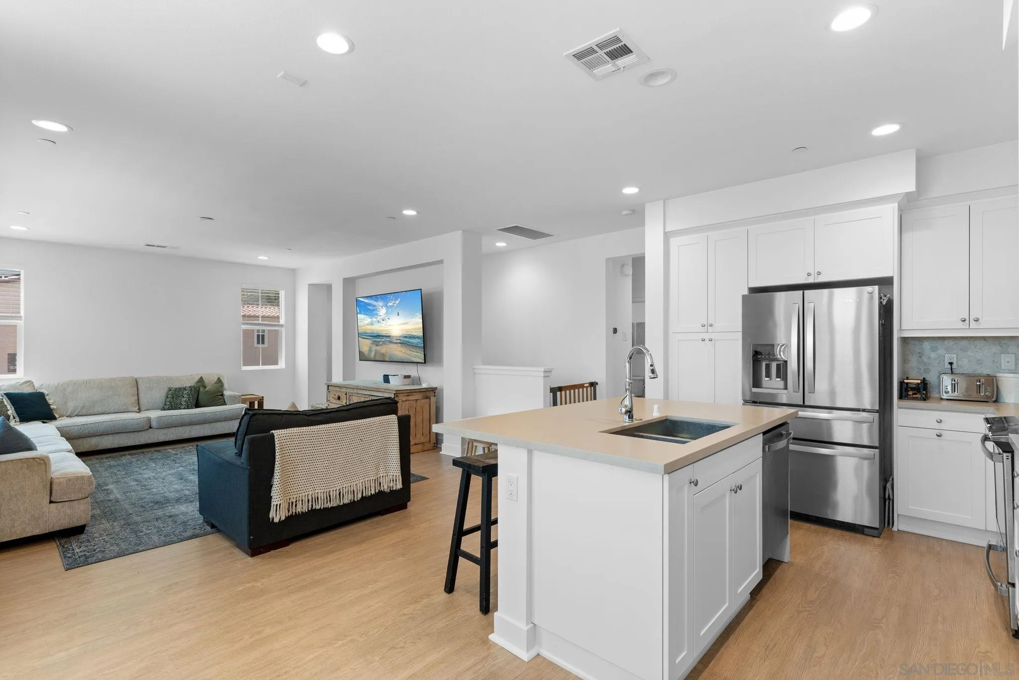 a kitchen that has a lot of cabinets a sink and a refrigerator