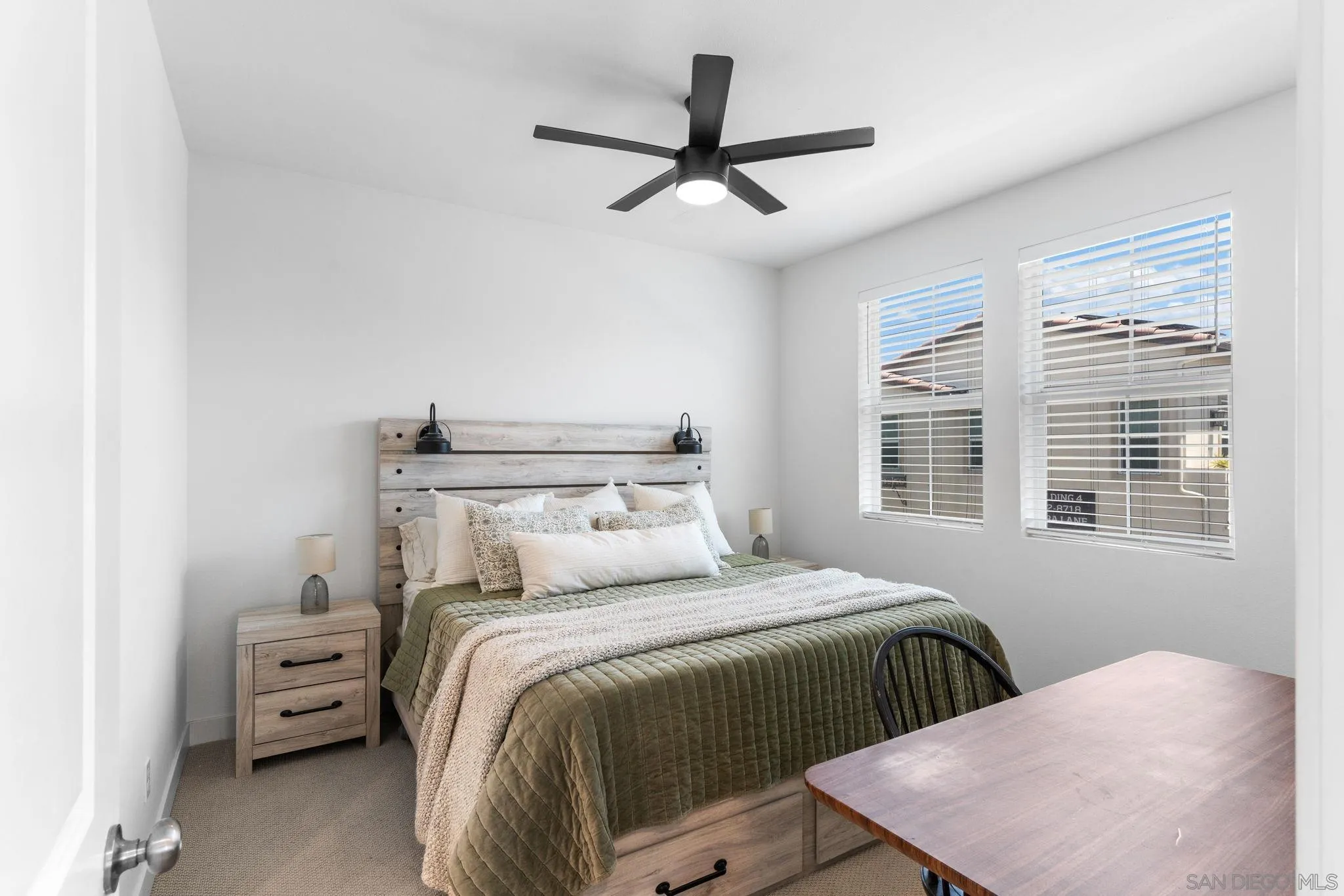 8702 Barbados Lane Santee, CA 92071 - Photo 20 of 39 a bedroom with a bed a window and a chandelier