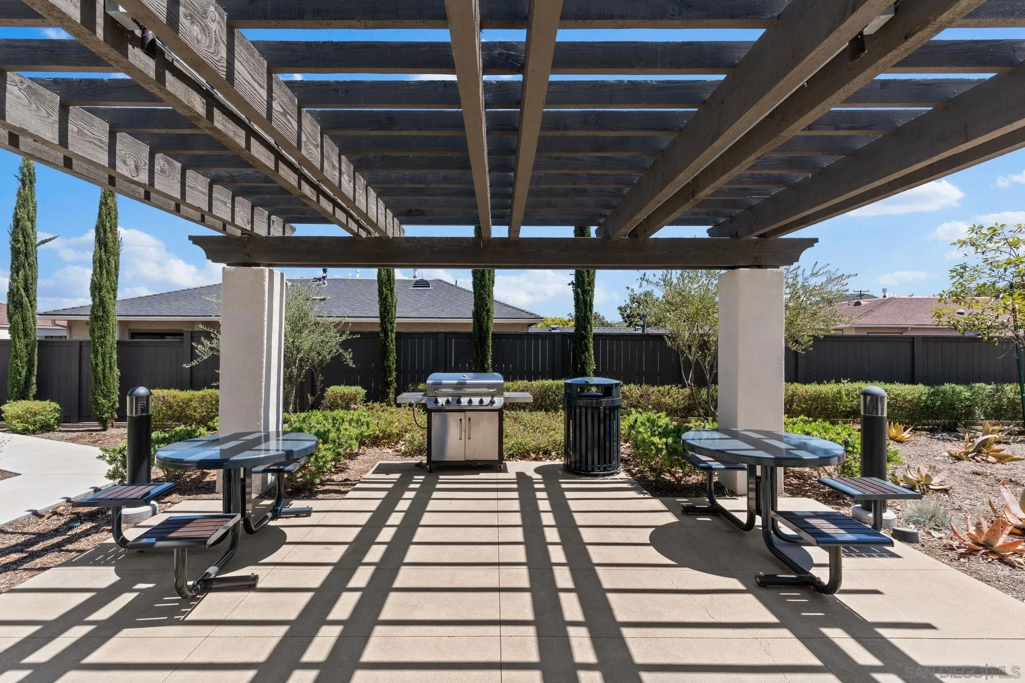 8702 Barbados Lane Santee, CA 92071 - Photo 37 of 39 a view of a patio with table and chairs and potted plants