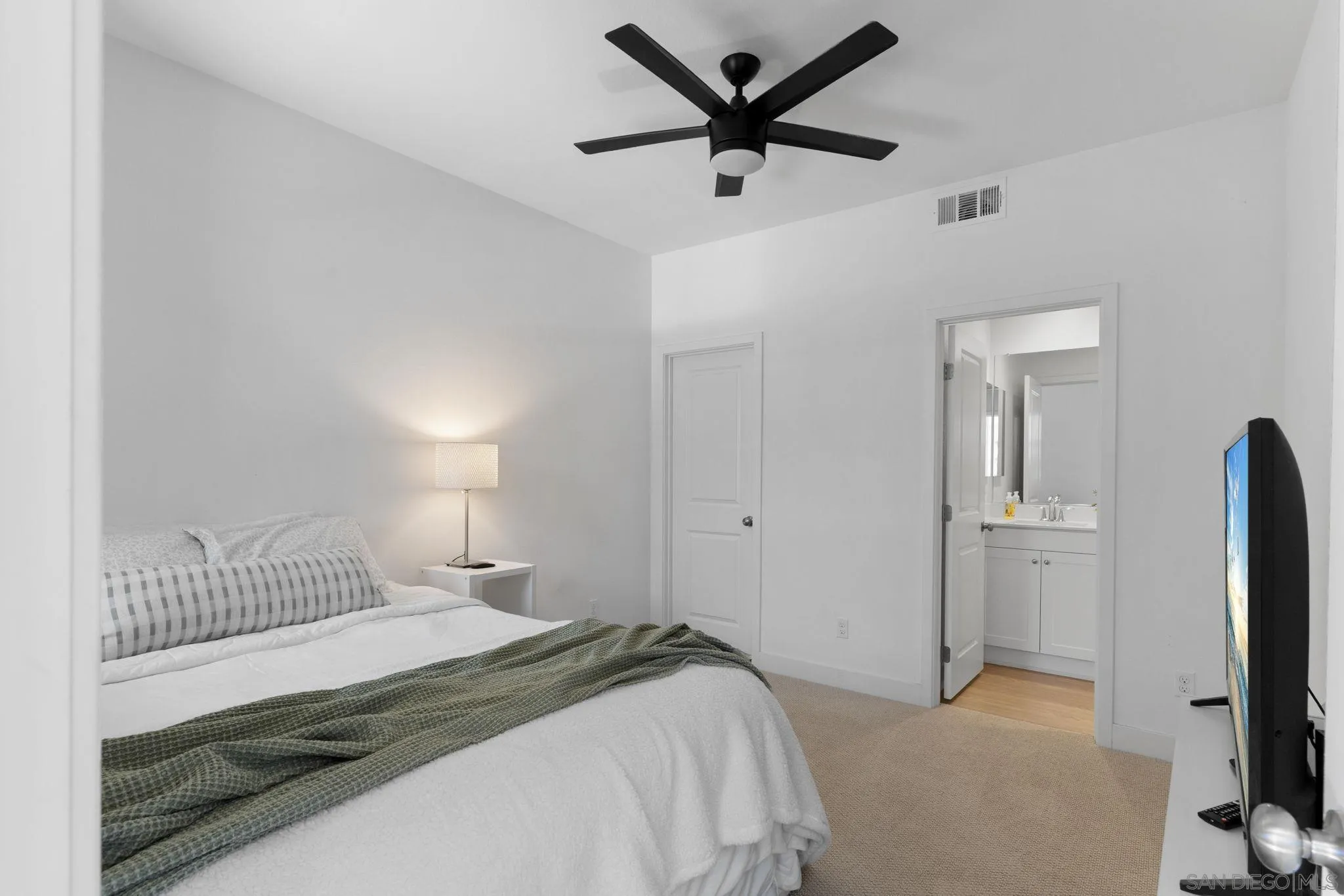 8702 Barbados Lane Santee, CA 92071 - Photo 7 of 39 a bedroom with a bed and a flat tv screen on the dresser
