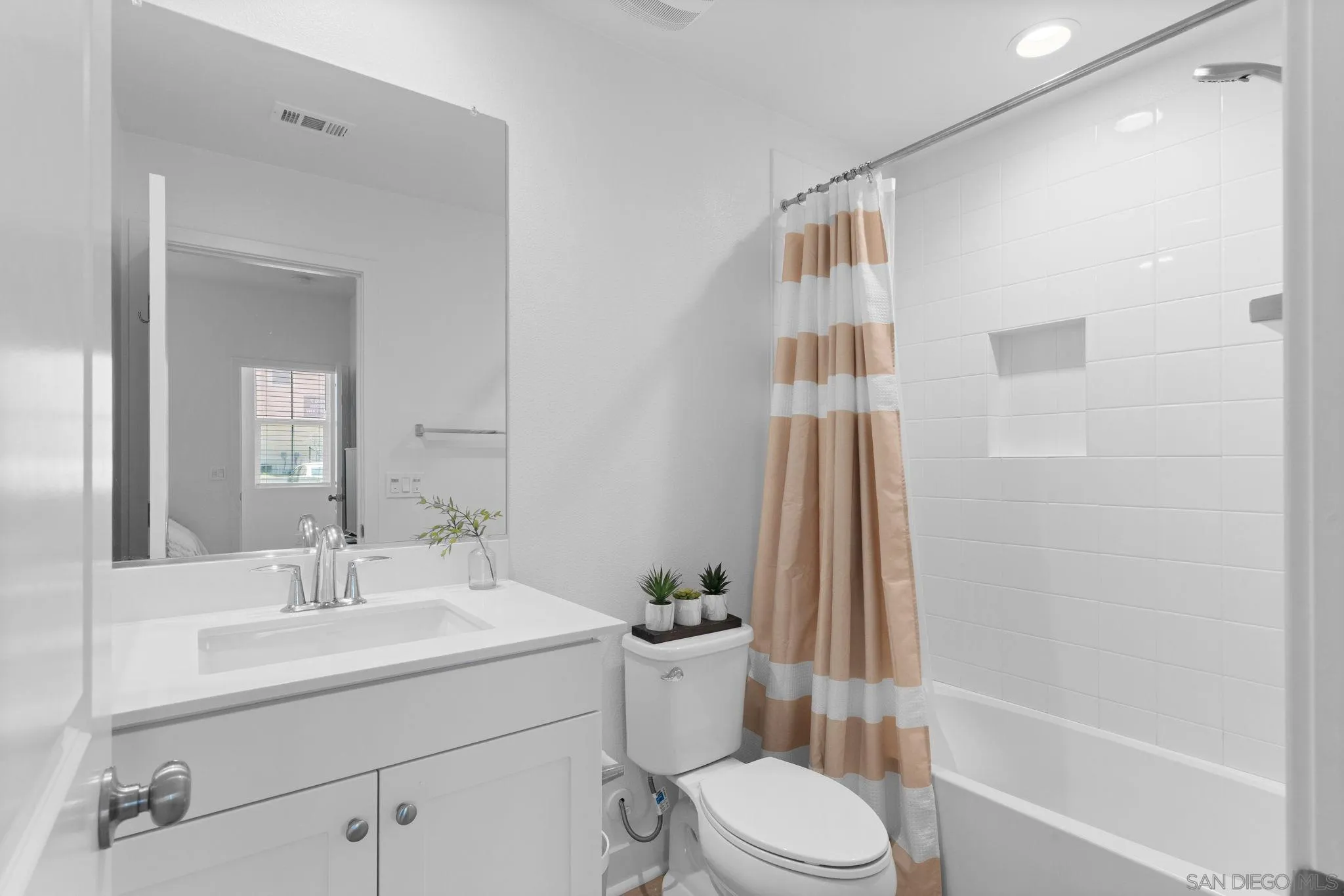 8702 Barbados Lane Santee, CA 92071 - Photo 9 of 39 a bathroom with a sink a toilet and shower