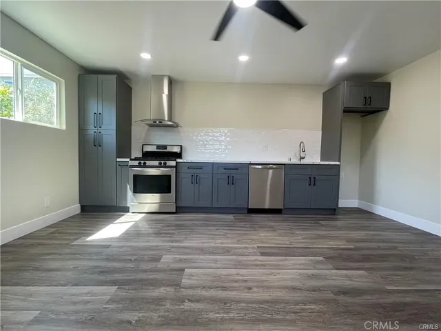 a view of kitchen with stove and wooden floor
