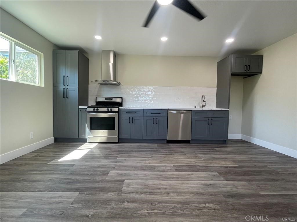 a view of kitchen with stove and wooden floor