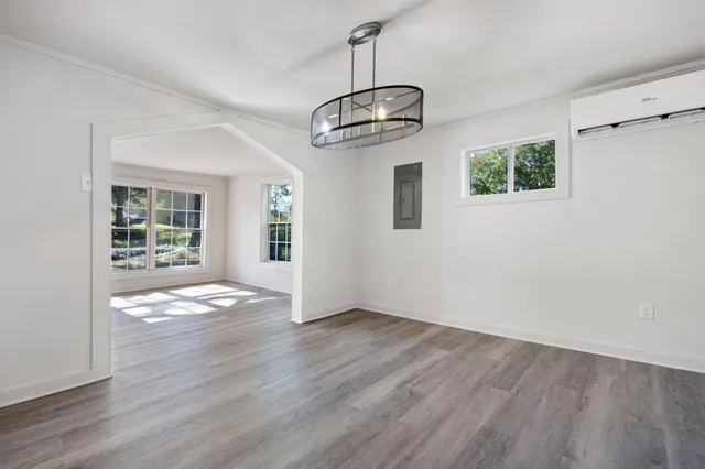 a view of empty room with wooden floor