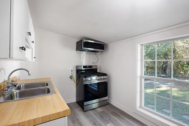 a kitchen with white cabinets and appliances