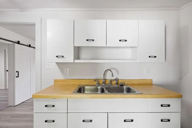 a view of kitchen with livingroom window and wooden floor