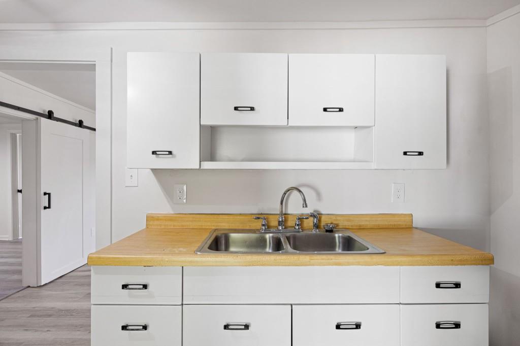 24 East Iron Belt Road Southeast Cartersville, GA 30120 - Photo 18 of 35 a kitchen with a sink a stove and cabinets