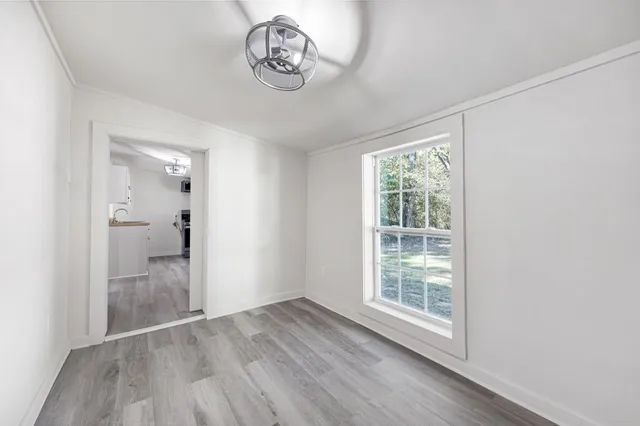 wooden floor in an empty room with a ceiling fan