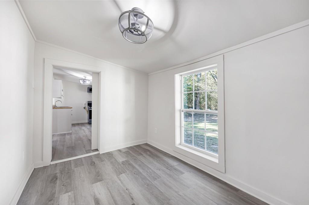 24 East Iron Belt Road Southeast Cartersville, GA 30120 - Photo 21 of 35 an empty room with wooden floor and windows