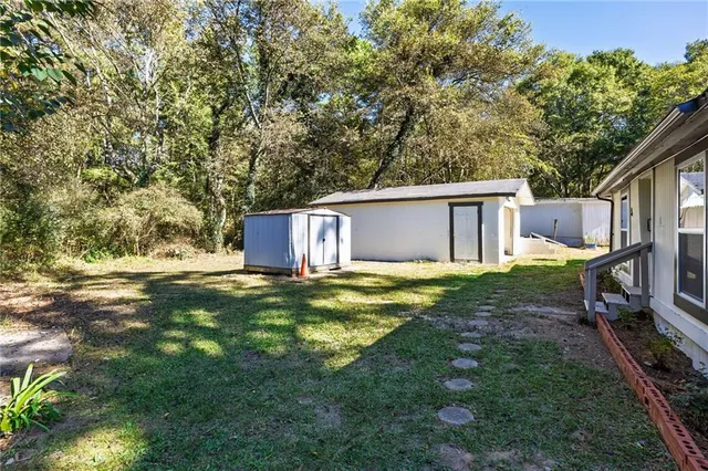 a backyard of a house with yard and outdoor seating