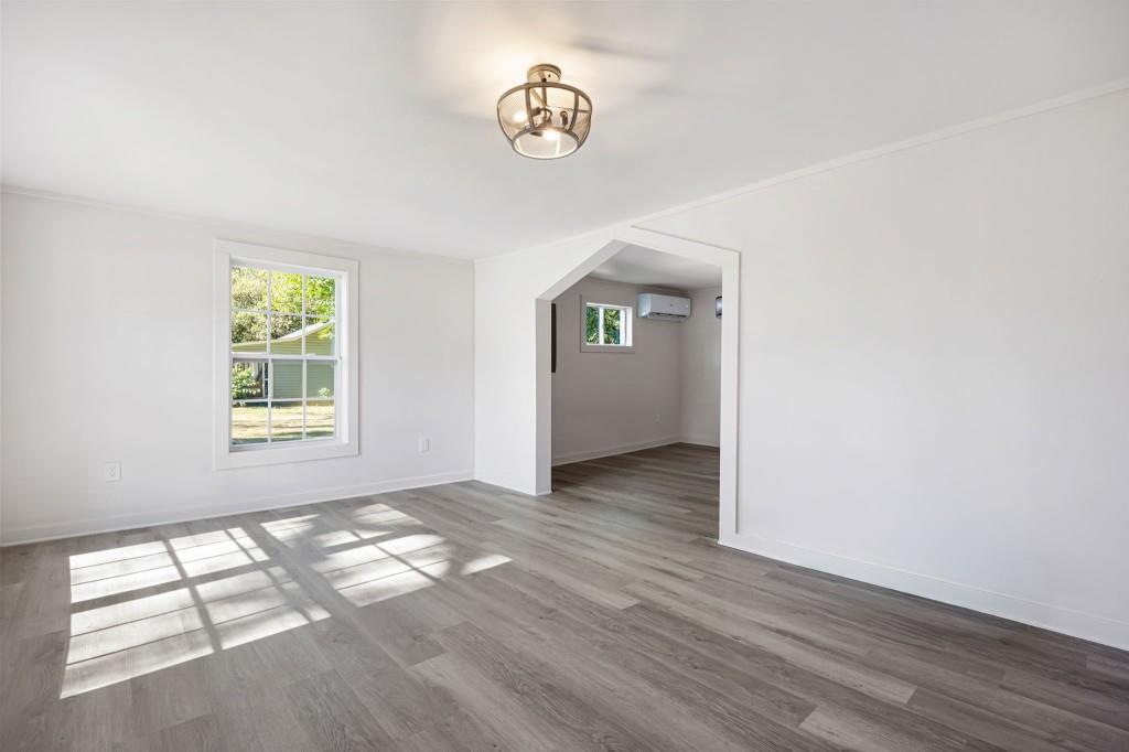 24 East Iron Belt Road Southeast Cartersville, GA 30120 - Photo 8 of 35 a view of an empty room with wooden floor and a window