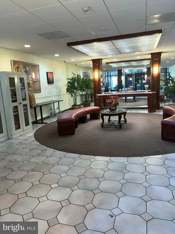 a living room with lots of furniture and a large mirror