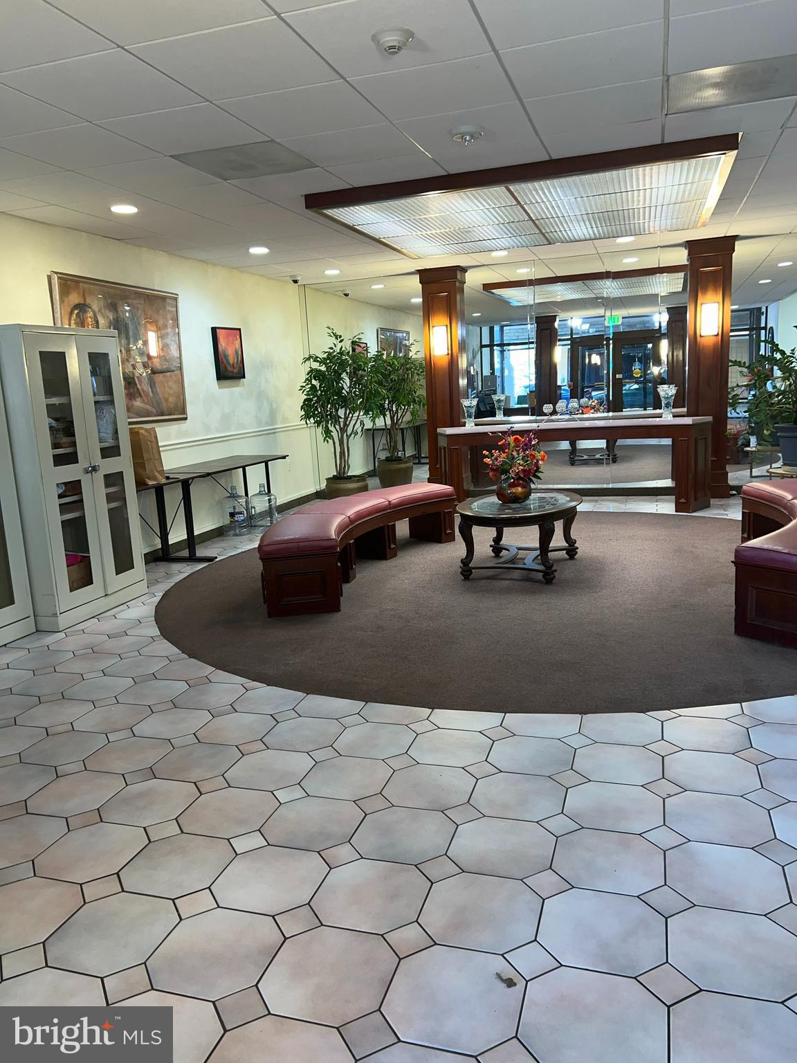 130 Slade Avenue, Unit 406 Baltimore, MD 21208 - Photo 3 of 11 a living room with lots of furniture and a large mirror