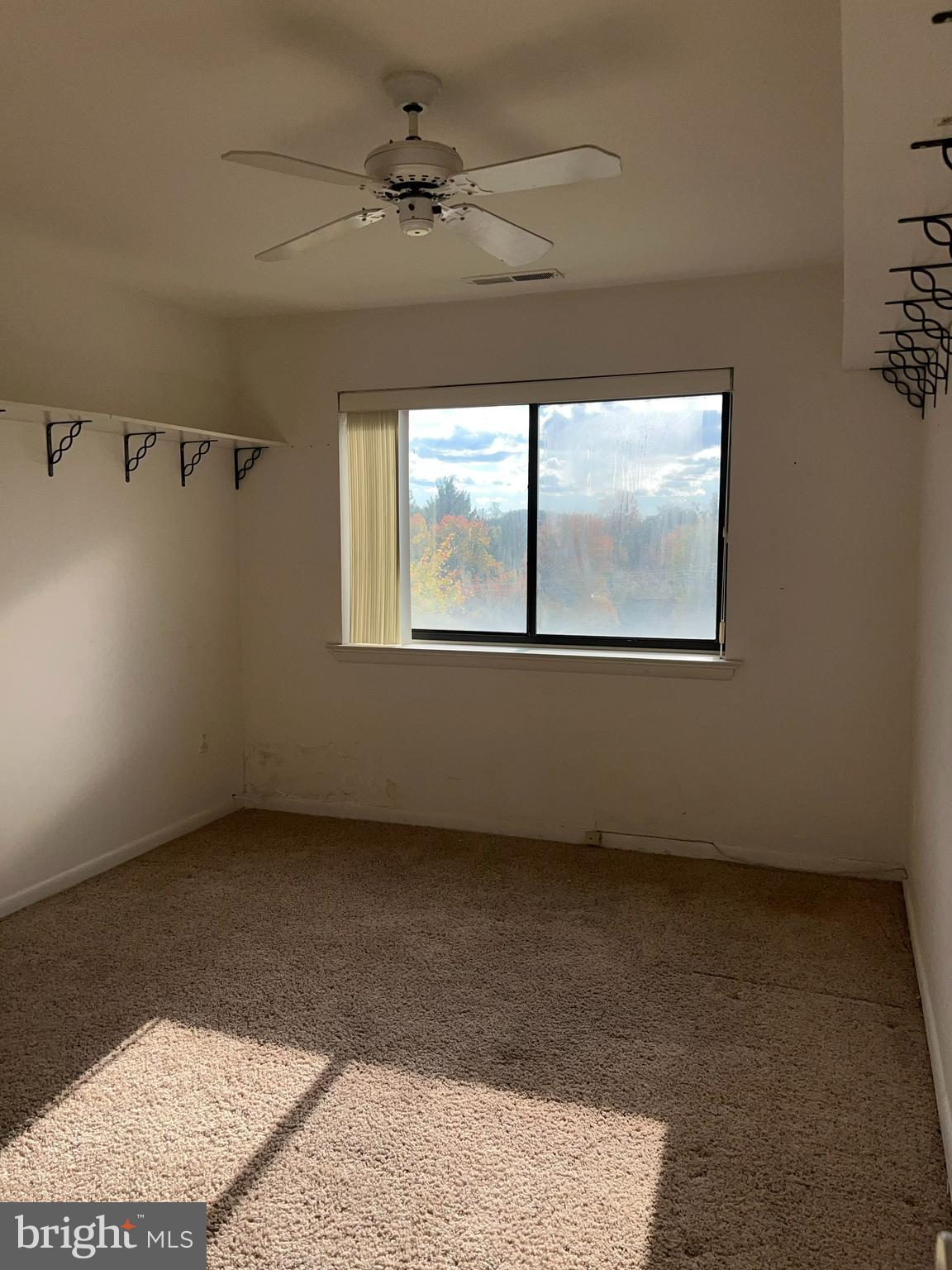 130 Slade Avenue, Unit 406 Baltimore, MD 21208 - Photo 10 of 11 an empty room with windows