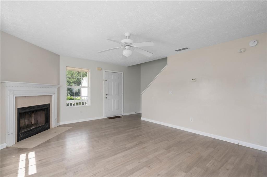 57 Inverness Trace Riverdale, GA 30274 - Photo 5 of 30 a view of an empty room with chandelier fan and fire place