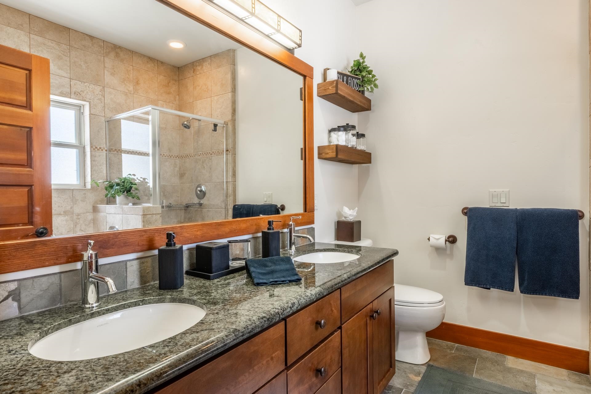 125 Davison Road, Unit 1 Mammoth Lakes, CA 93546 - Photo 20 of 46 a bathroom with a granite countertop double vanity sink a mirror and a toilet