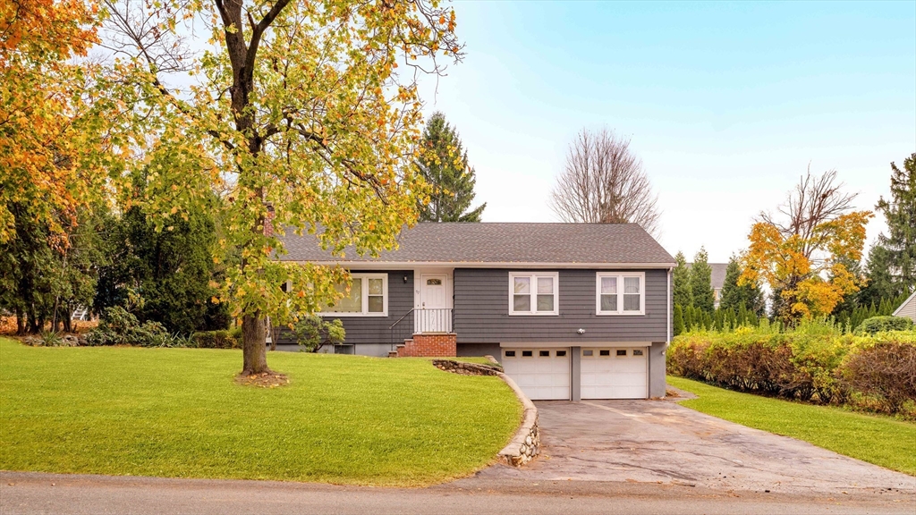 97 MacArthur Road Stoneham, MA 02180 - Photo 1 of 30 a front view of house with yard and trees around