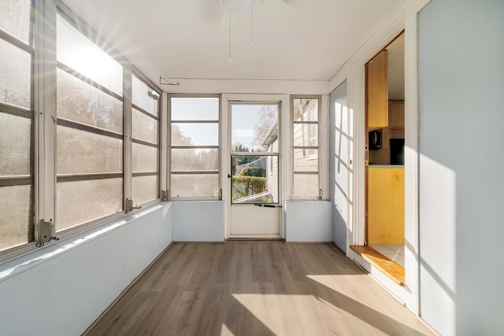 97 MacArthur Road Stoneham, MA 02180 - Photo 17 of 30 a view of a big room with wooden floor and windows