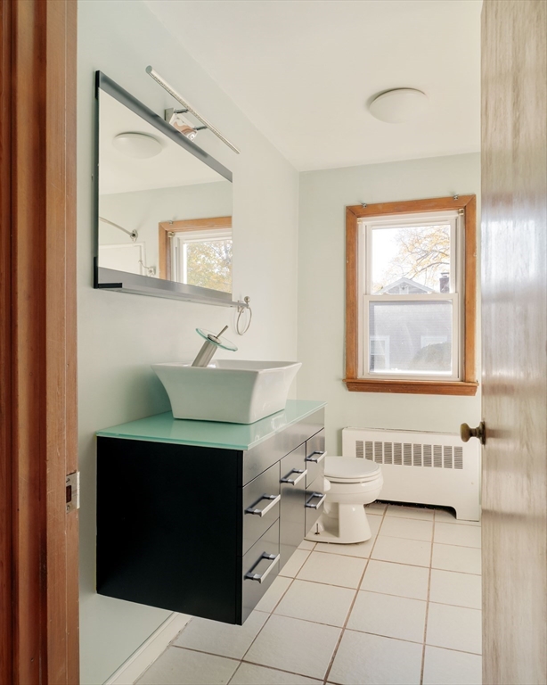 97 MacArthur Road Stoneham, MA 02180 - Photo 20 of 30 a bathroom with a sink a mirror and a bathtub
