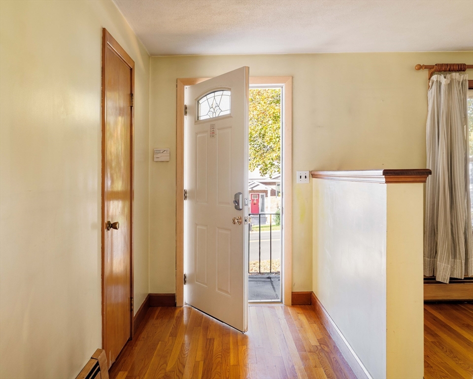 97 MacArthur Road Stoneham, MA 02180 - Photo 2 of 30 a view of a hallway with wooden floor and closet