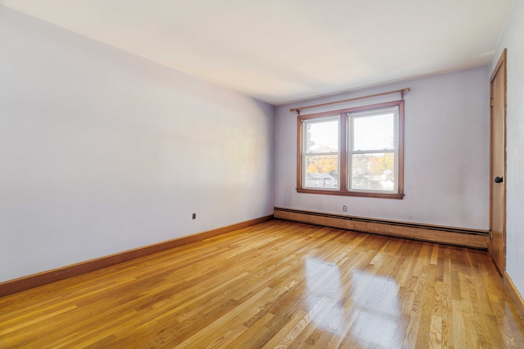 97 MacArthur Road Stoneham, MA 02180 - Photo 22 of 30 an empty room with wooden floor and windows