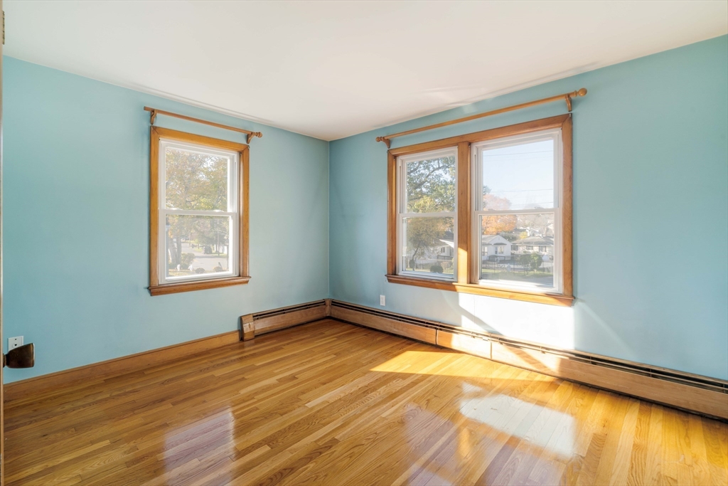 97 MacArthur Road Stoneham, MA 02180 - Photo 24 of 30 a view of an empty room with wooden floor and a window