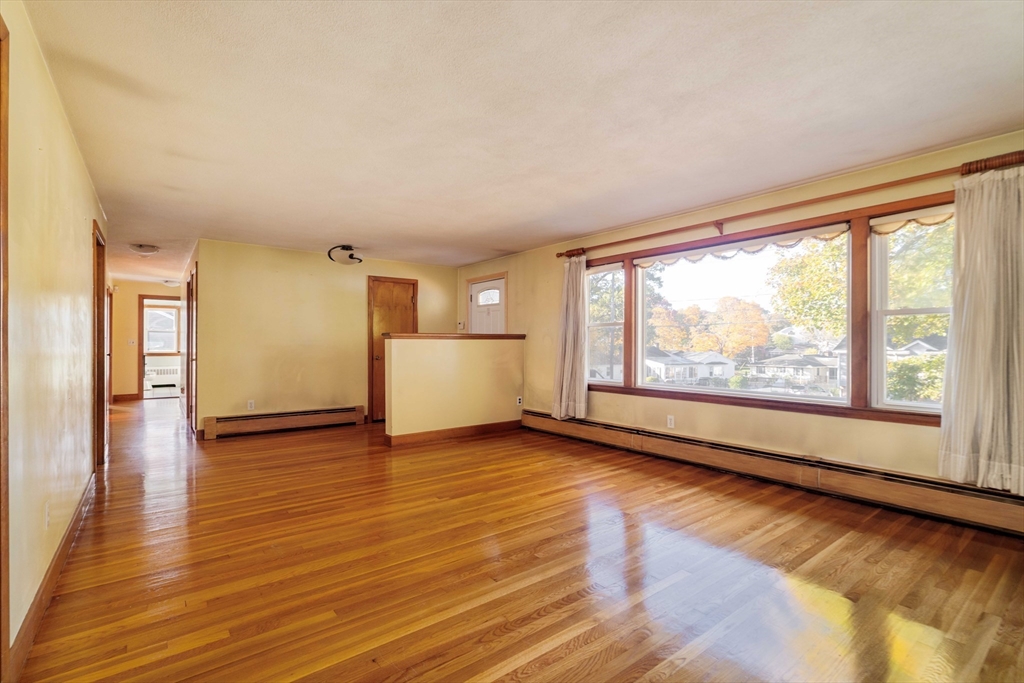 97 MacArthur Road Stoneham, MA 02180 - Photo 3 of 30 a view of empty room with wooden floor and fan