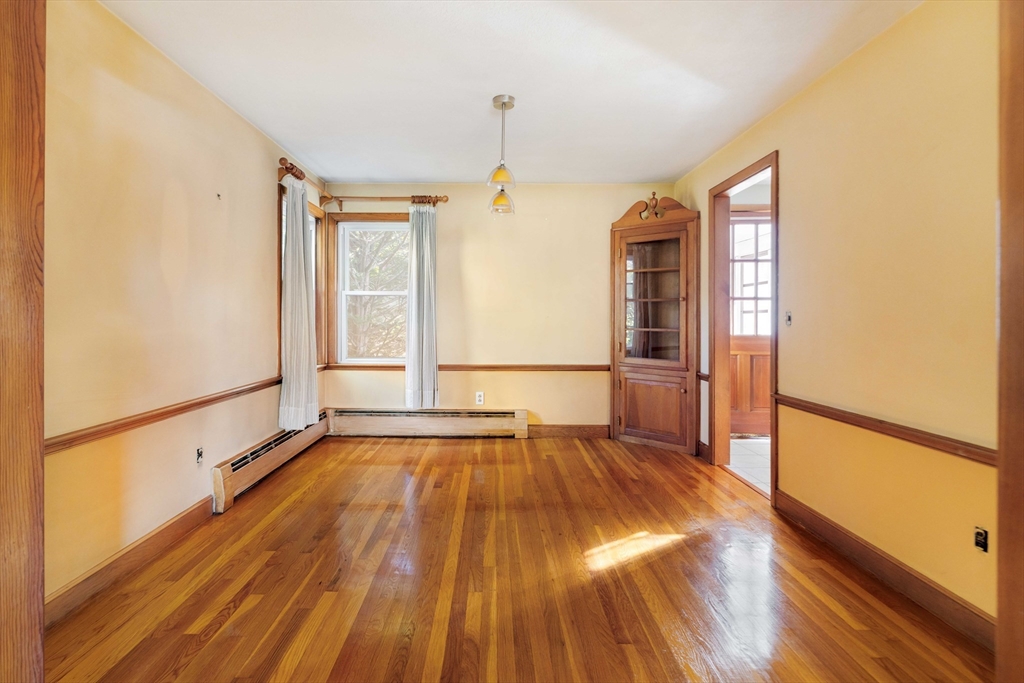 97 MacArthur Road Stoneham, MA 02180 - Photo 9 of 30 a view of empty room with wooden floor and fan