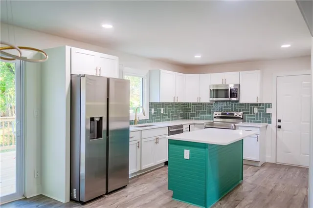 a kitchen with a refrigerator a sink and dishwasher