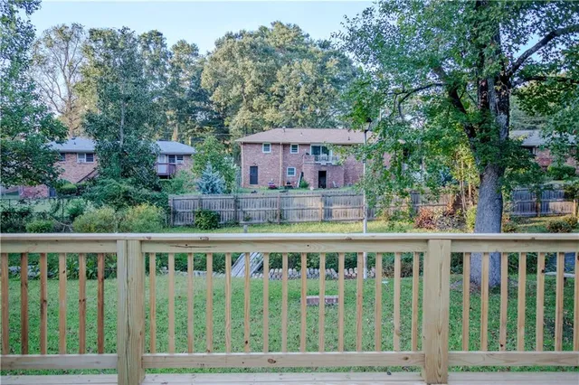 a view of a house with wooden deck