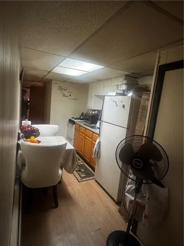 a room with table chairs and appliances