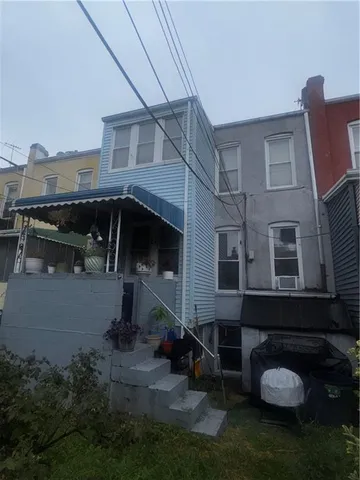 a view of residential houses with outdoor space and garden